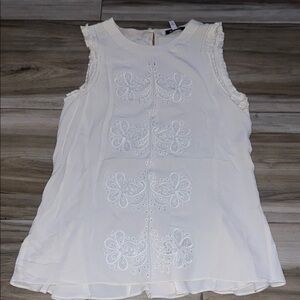 White Sleeveless Top with Embroidered Design peplum